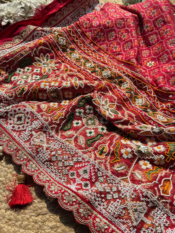 Royal Red Patola-Inspired Designer Saree with Intricate Beadwork, Traditional Motifs and Scalloped Lace Border