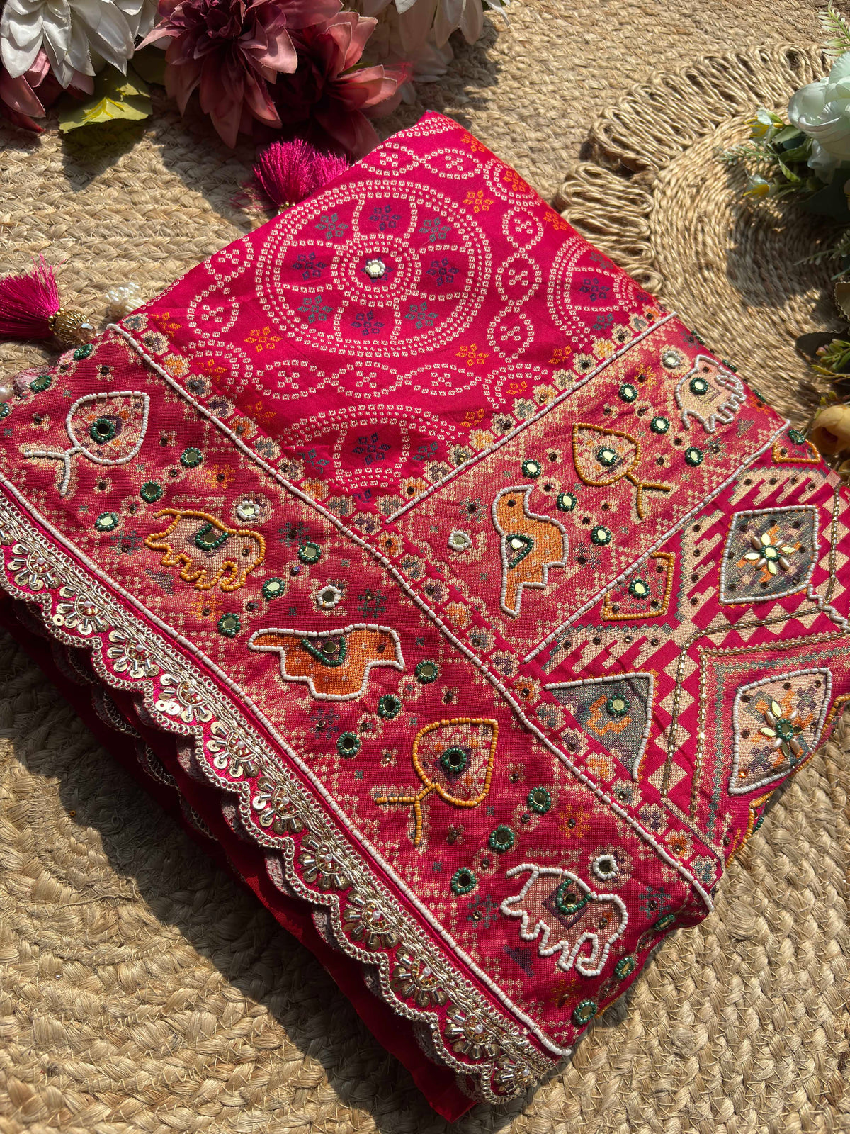 Rani Pink Bandhani Designer Saree with Traditional Elephant Motifs, Intricate Pearl Beadwork, Mirror Embellishments, Gold Zari Detailing and Scalloped Lace Border