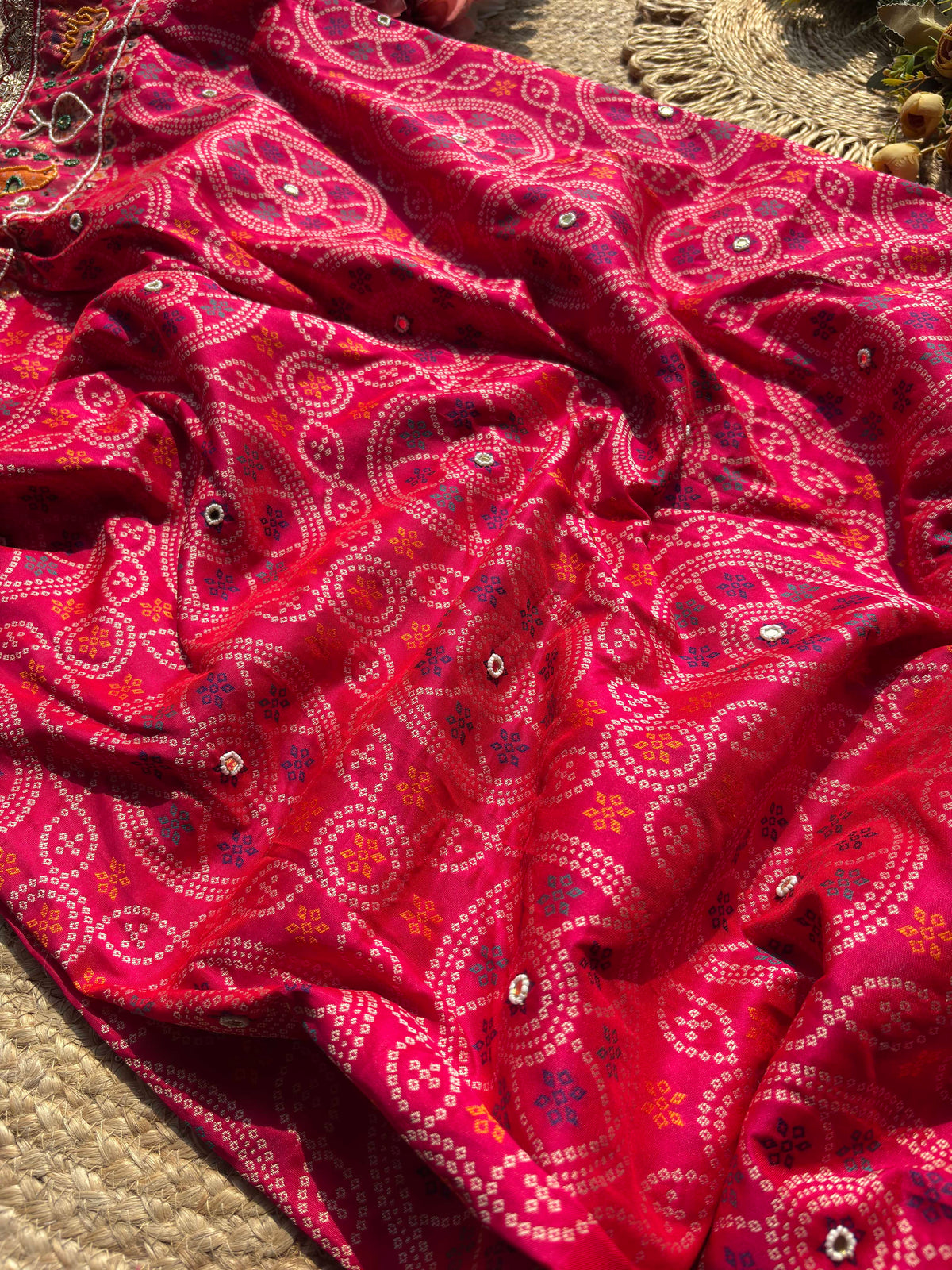 Rani Pink Bandhani Designer Saree with Traditional Elephant Motifs, Intricate Pearl Beadwork, Mirror Embellishments, Gold Zari Detailing and Scalloped Lace Border