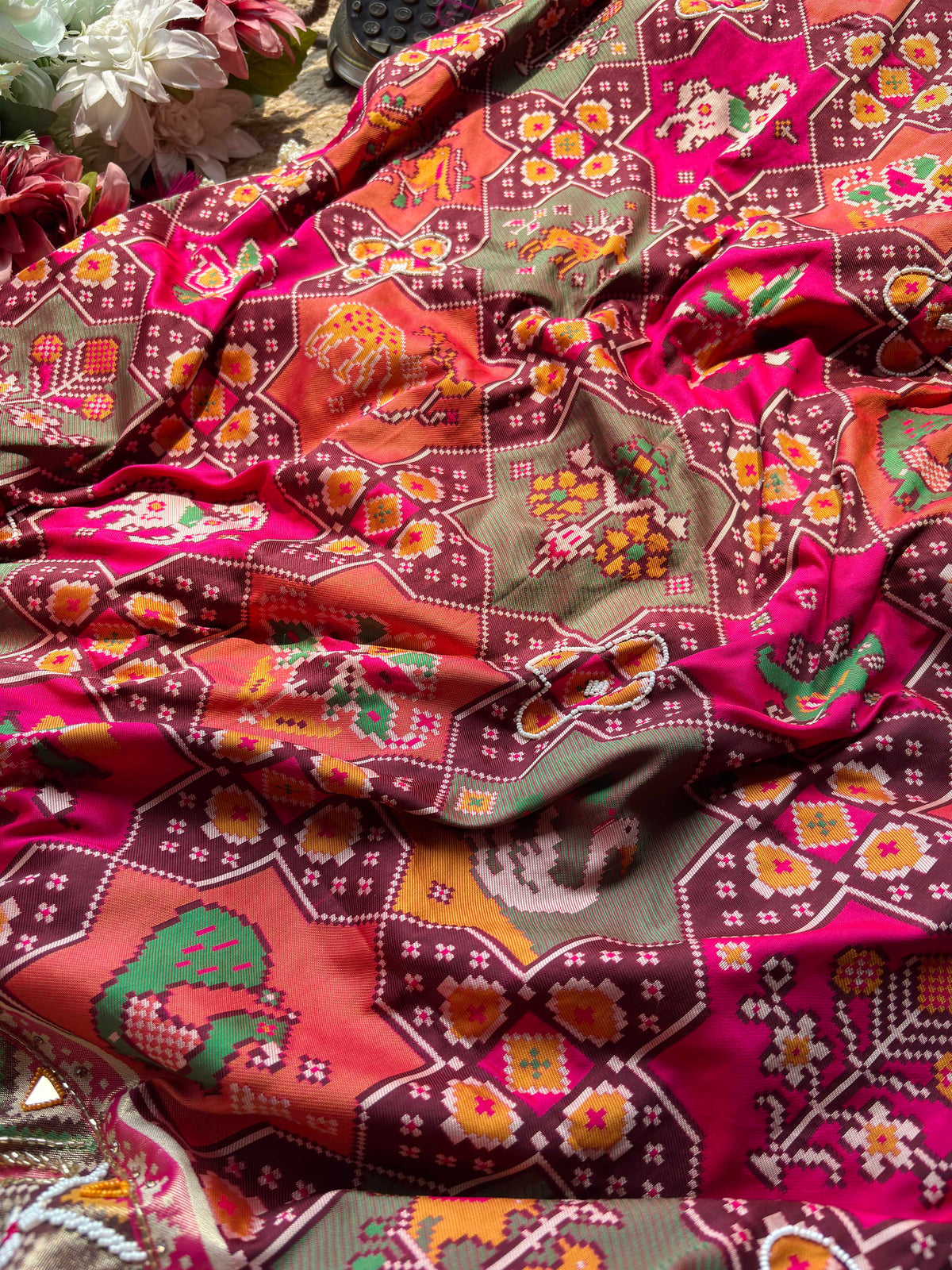 Rani Pink Patola Saree with Animal Motifs & Embellished Border